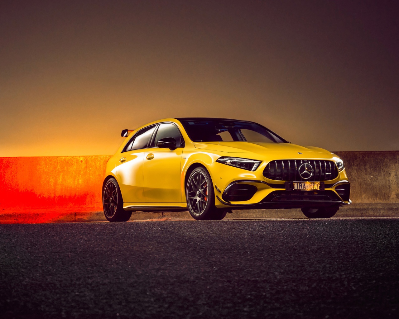 Желтый автомобиль Mercedes-AMG A 45 S,  2020 года на асфальте 