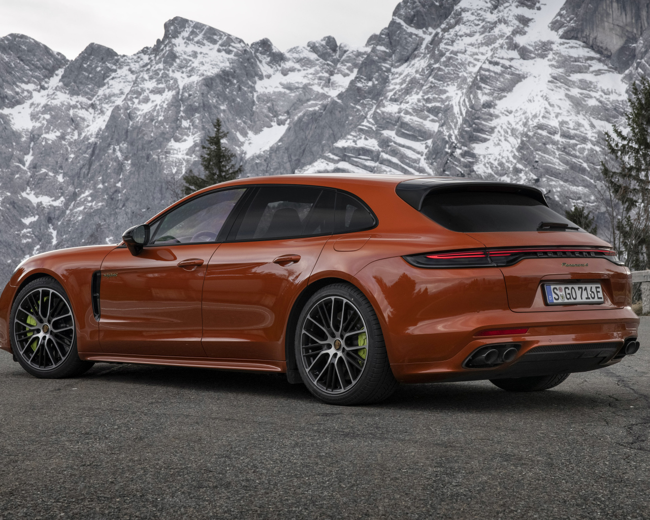 Красный автомобиль Porsche Panamera 4 E-Hybrid 2021 года на фоне гор