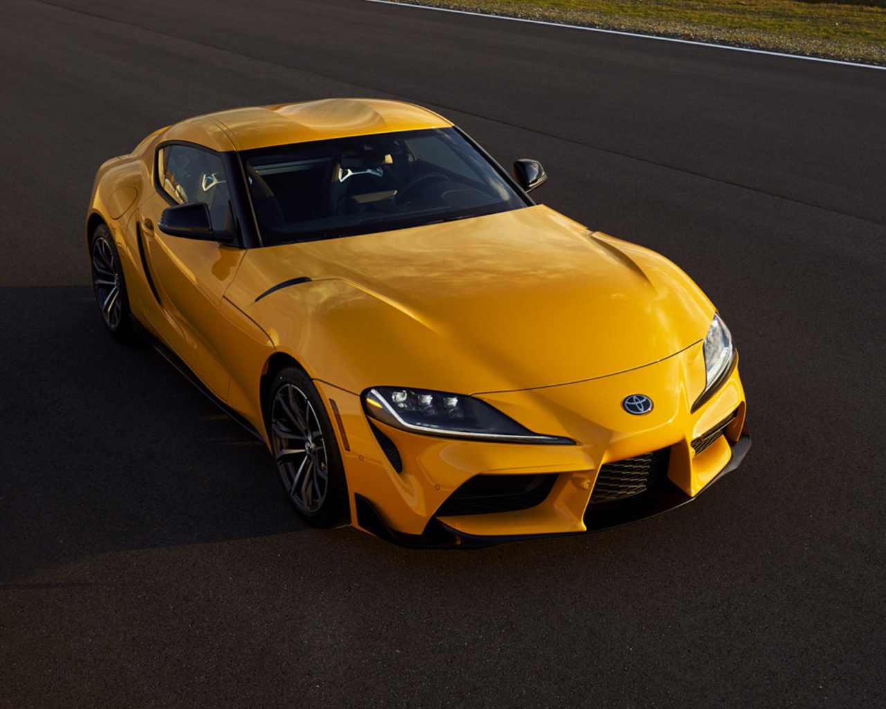 Желтый автомобиль  Toyota GR Supra, 2021 года на трассе 