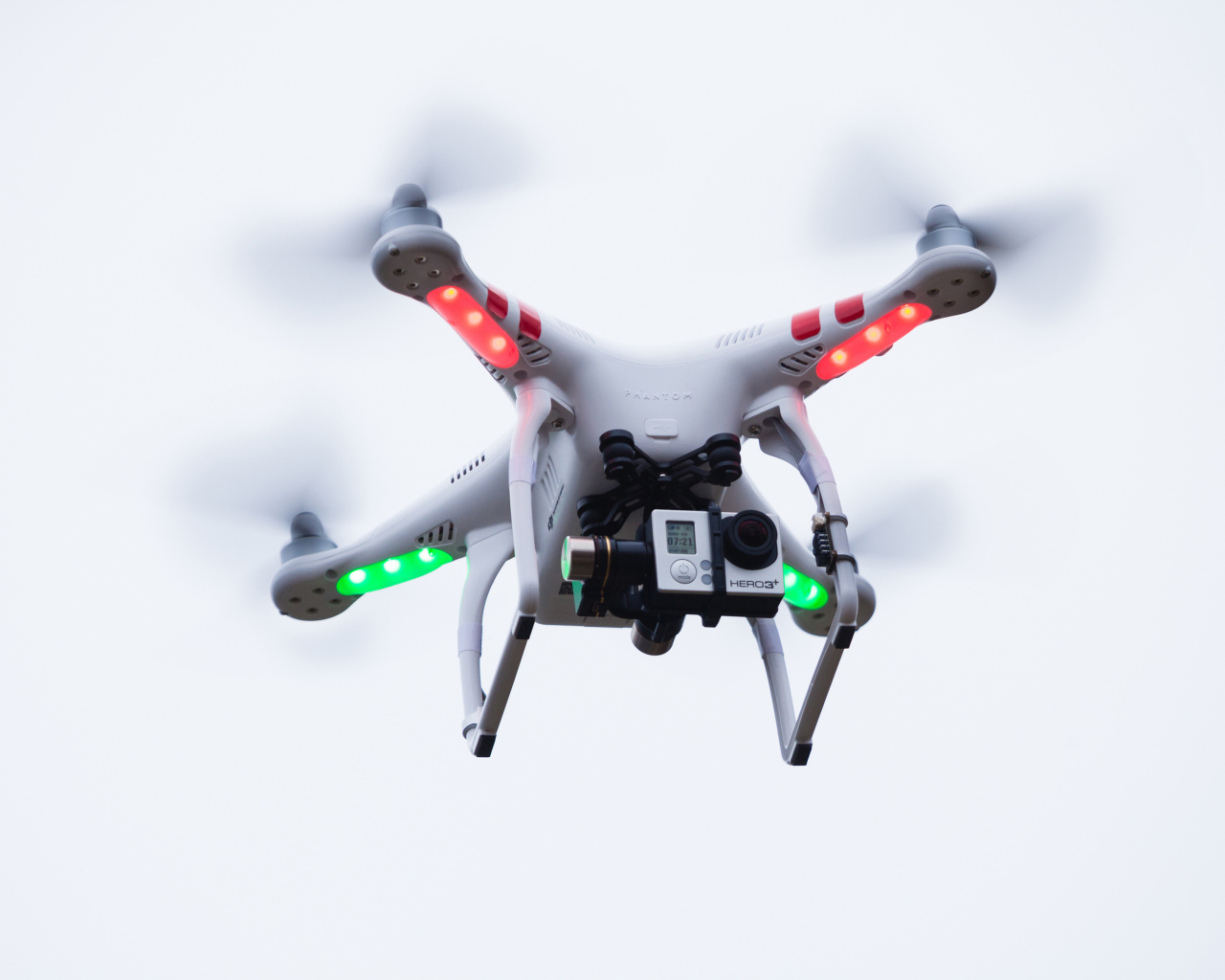 Квадрокоптер с видеокамерой на белом фоне
