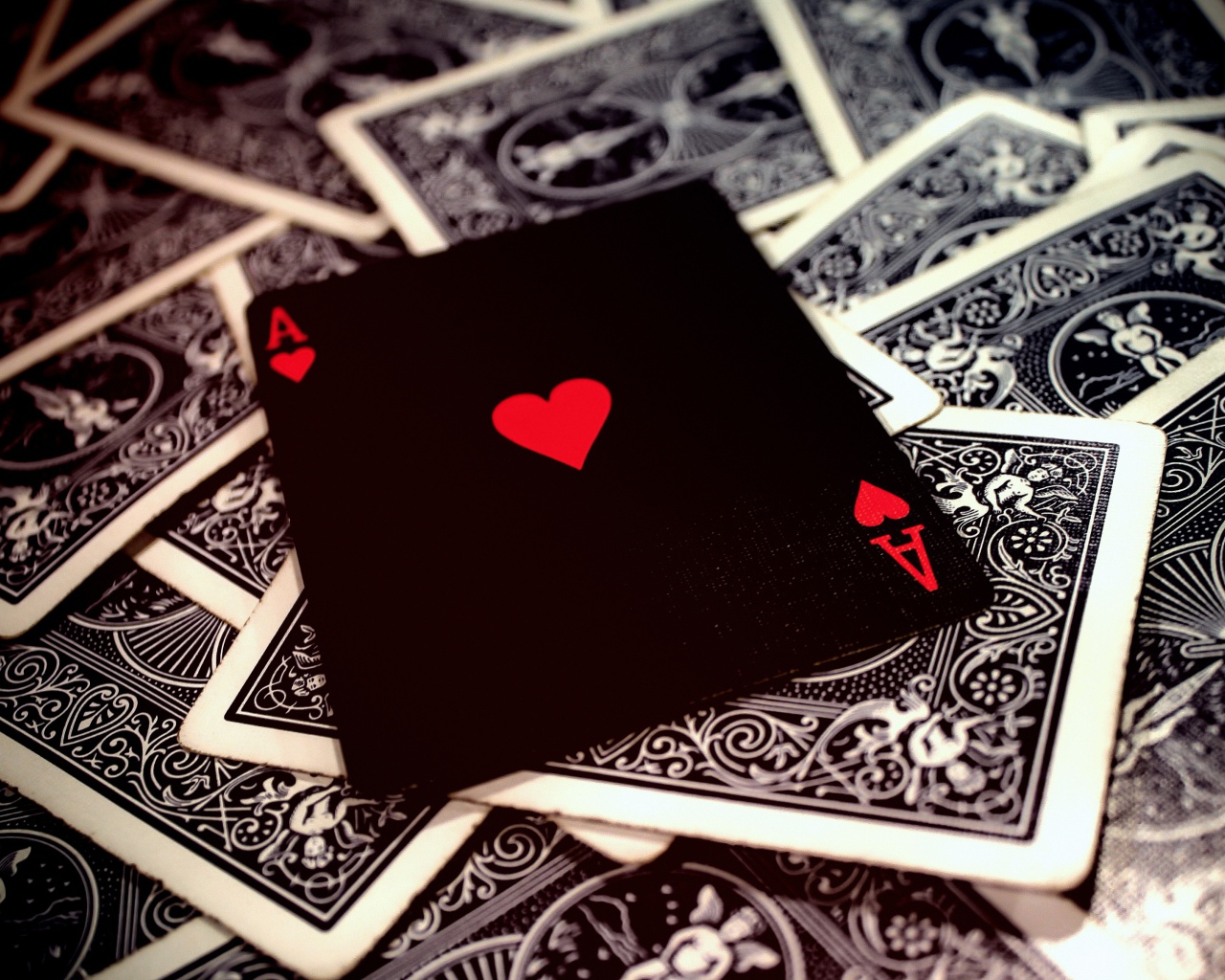 Ace of hearts lies on a deck of cards