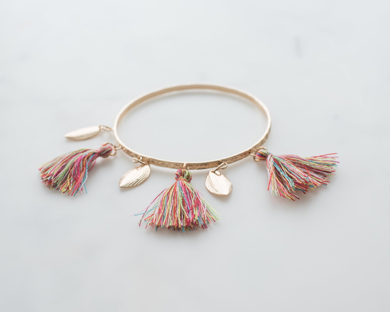 Золотой браслет на сером фоне