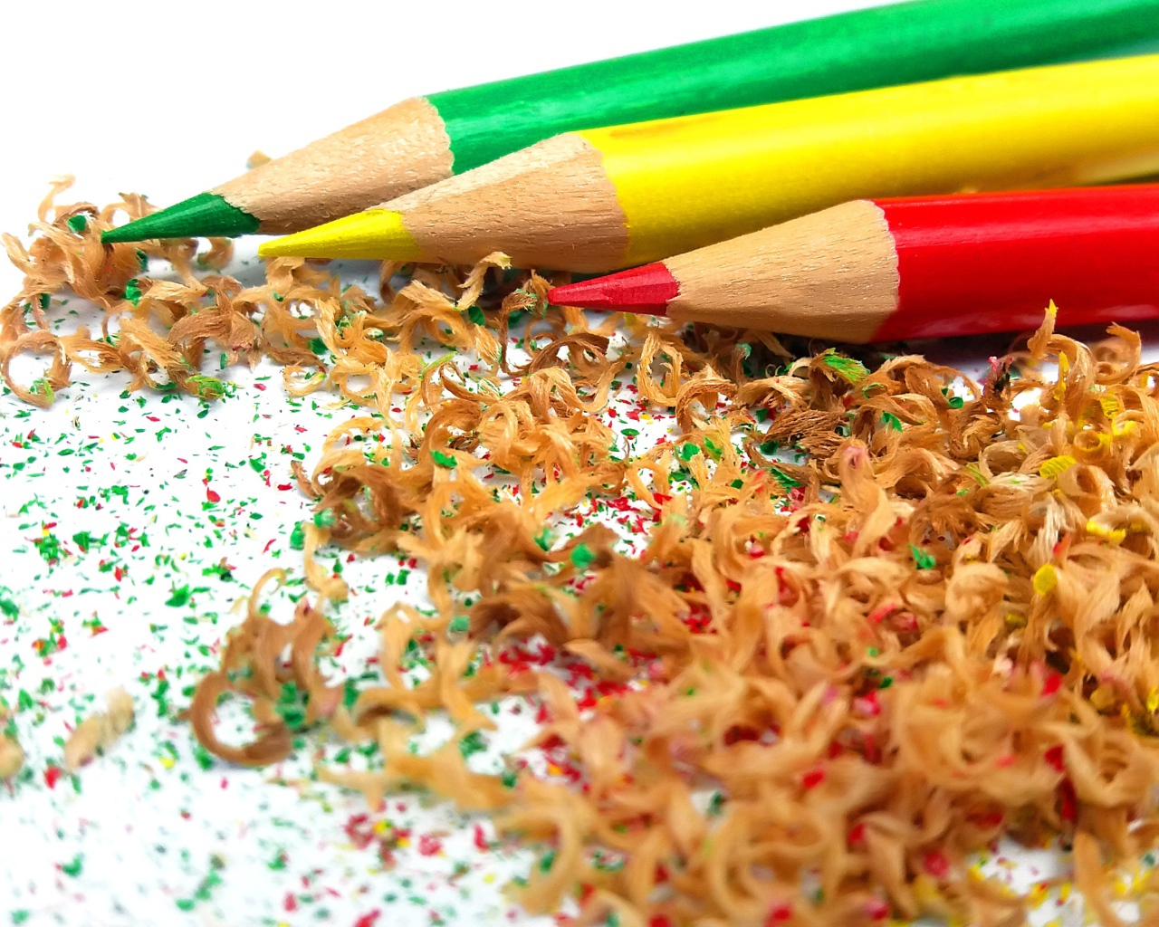 Sharp sharpened pencils with shavings on a white background