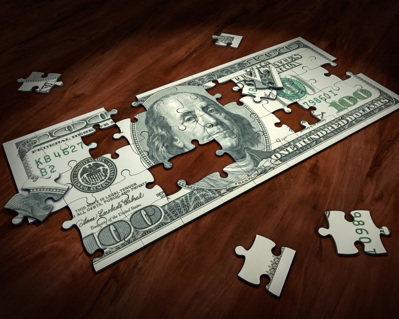 Пазл из купюры сто долларов на столе 