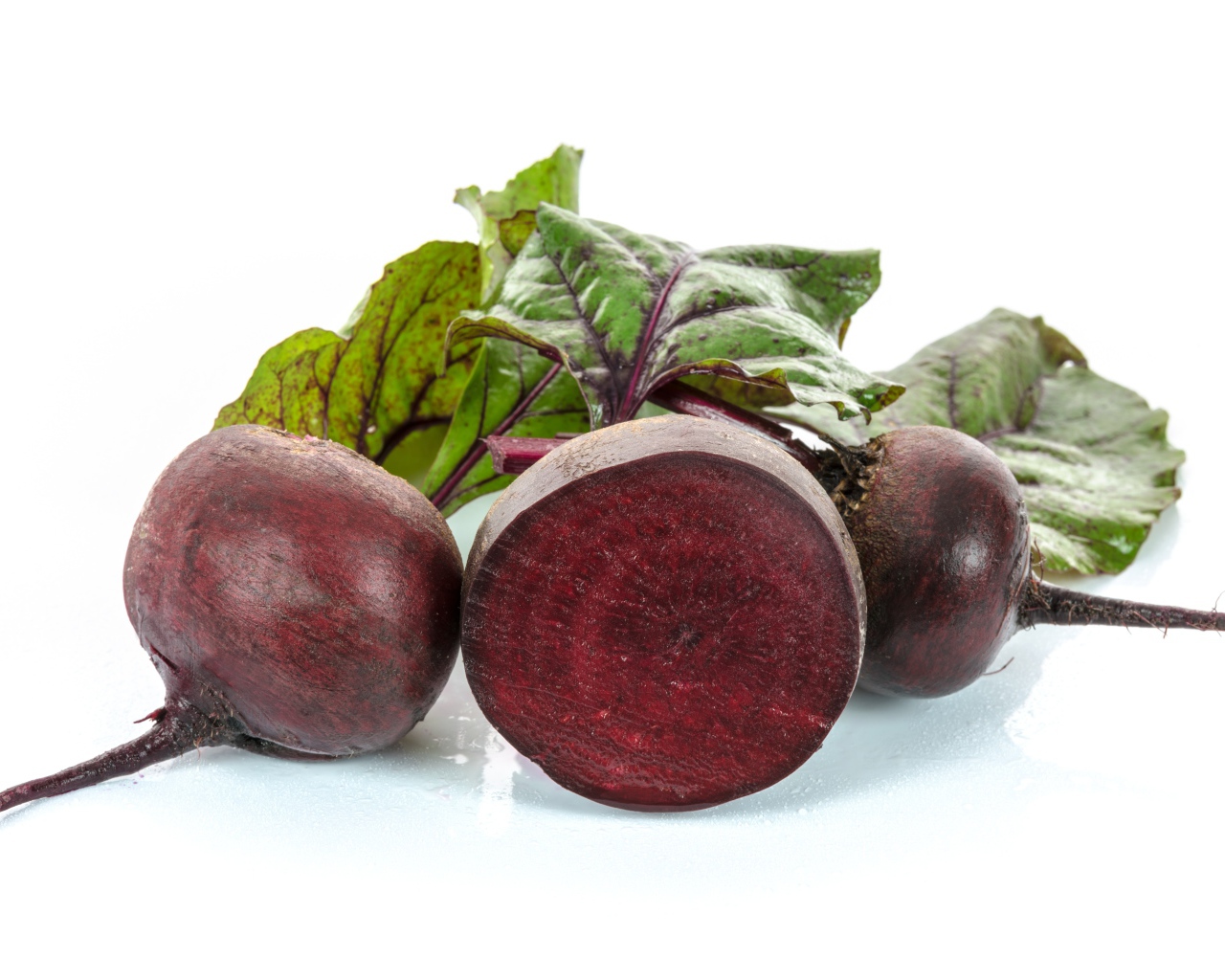 Beets with green leaves on a white background