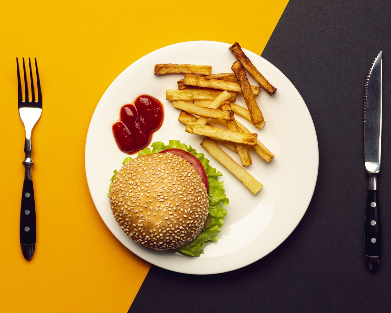 Гамбургер на белой тарелке с соусом и картофелем фри