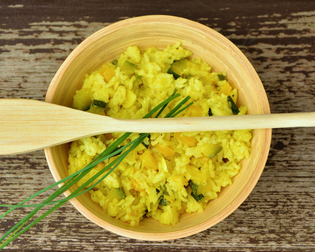 Блюдо ризотто в деревянной миске с ложкой