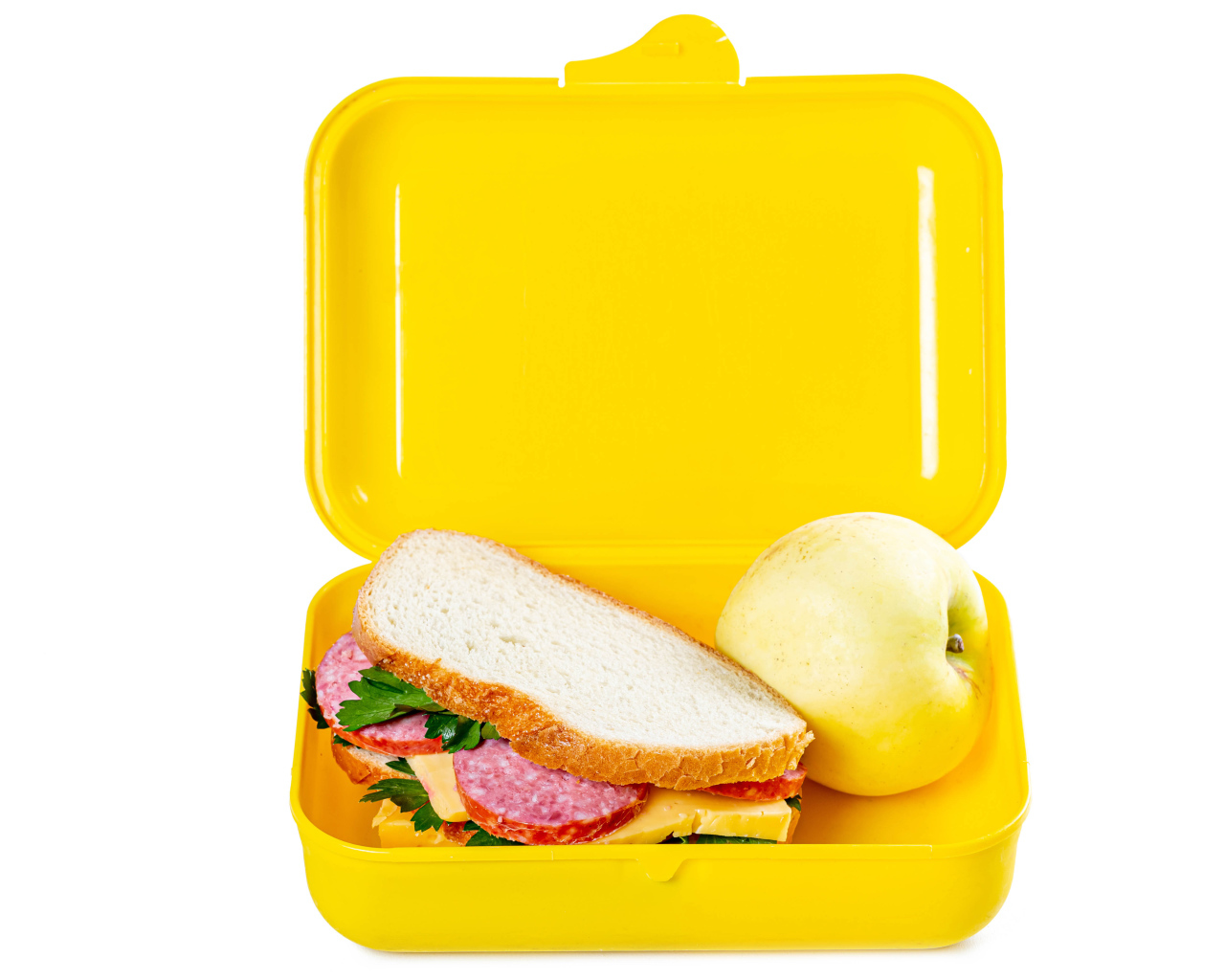 Бутерброд и яблоко в контейнере на белом фоне