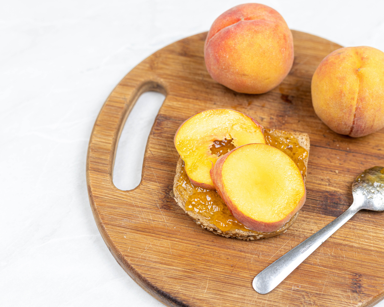 Свежие персики на столе с хлебом 