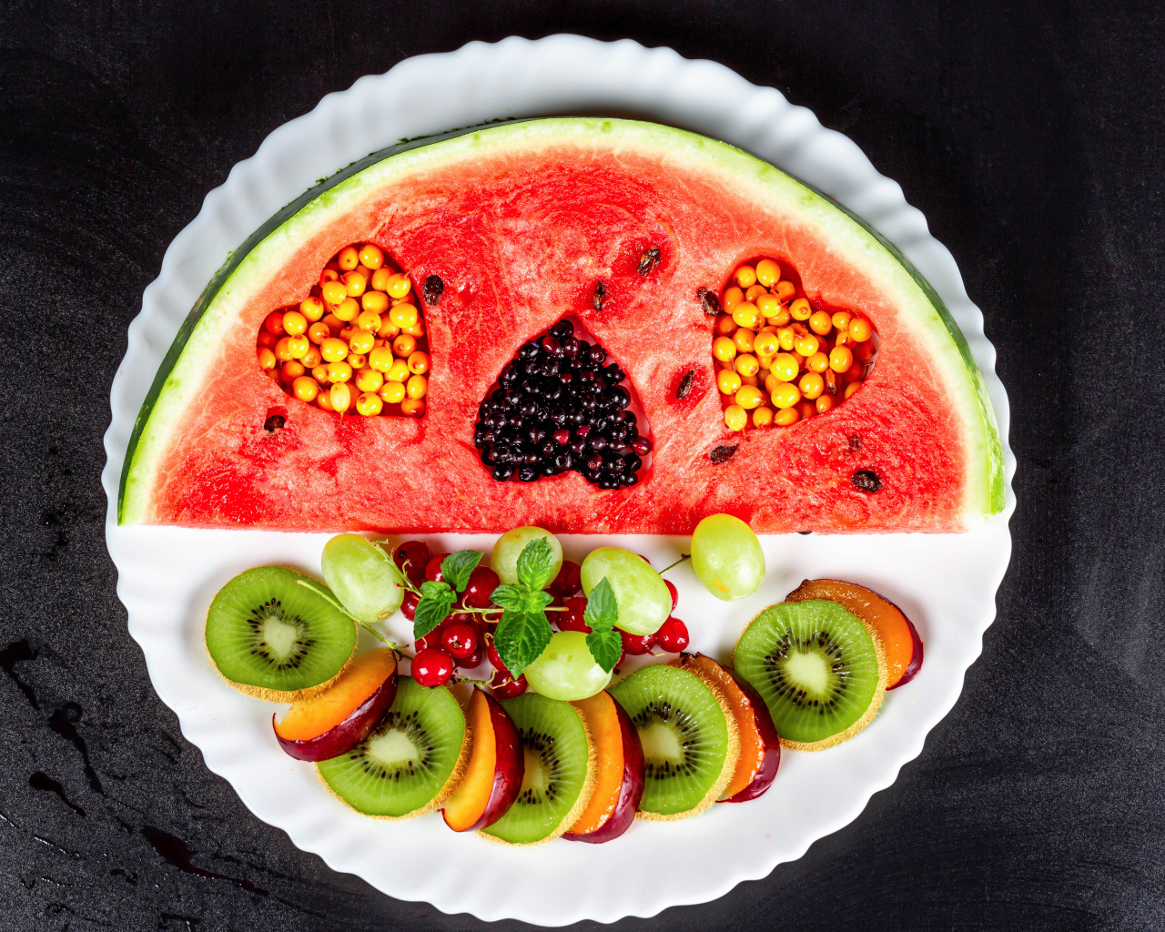 Watermelon on a plate with berries