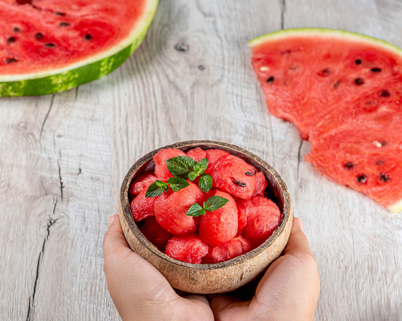 Watermelon pulp in a bowl in hands