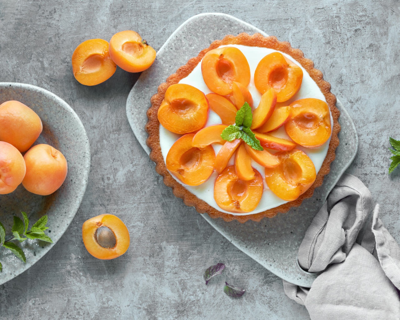 Cream cake with apricots on a table