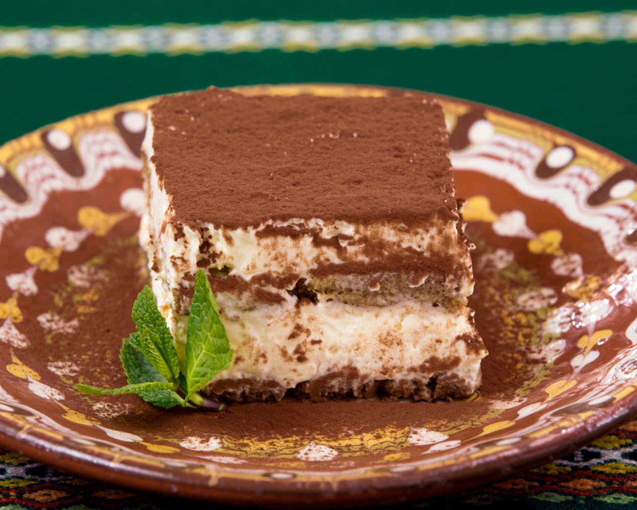 Кусок торта тирамису на тарелке 