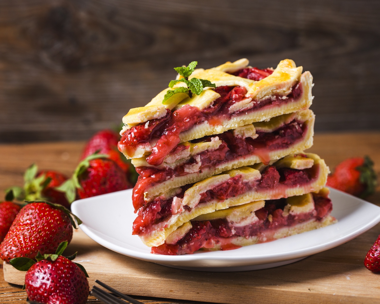 Пирог с ягодами клубники на белой тарелке 