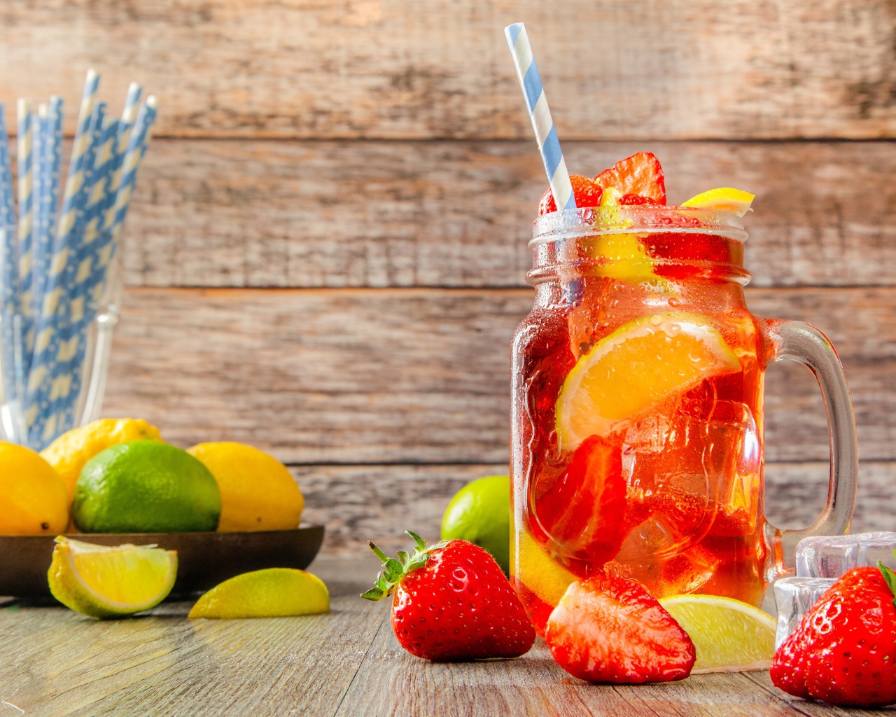 Напиток с клубникой и лимоном в банке на столе 