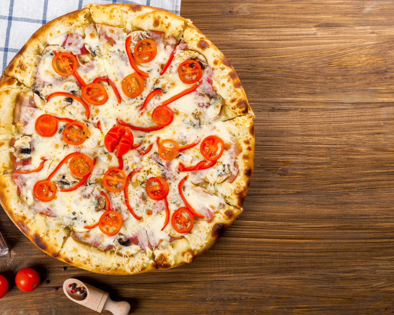 Пицца с беконом на столе с помидорами  и перцем