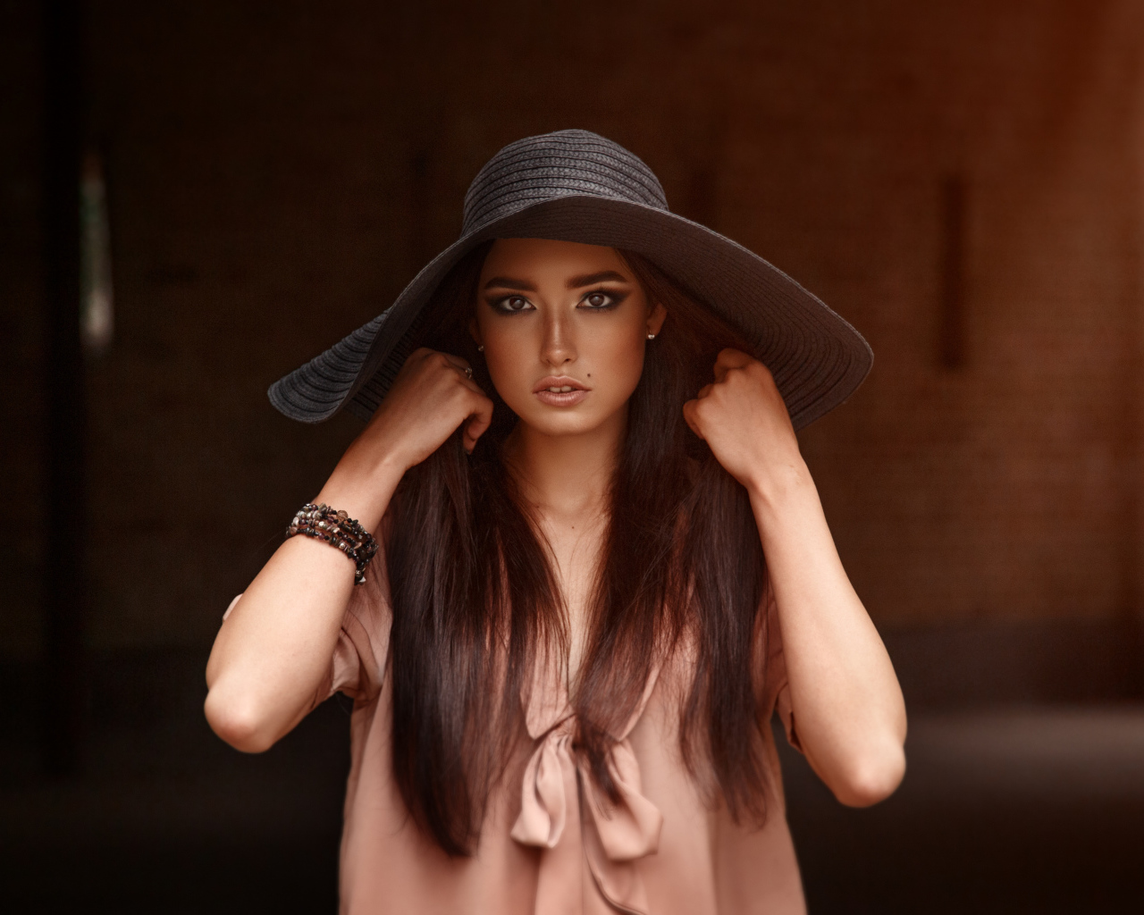 Красивая кареглазая брюнетка в большой шляпе 