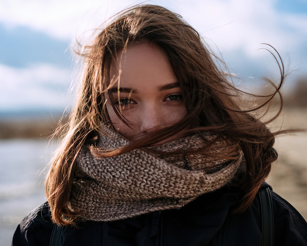Girl with a warm knitted scarf on her face