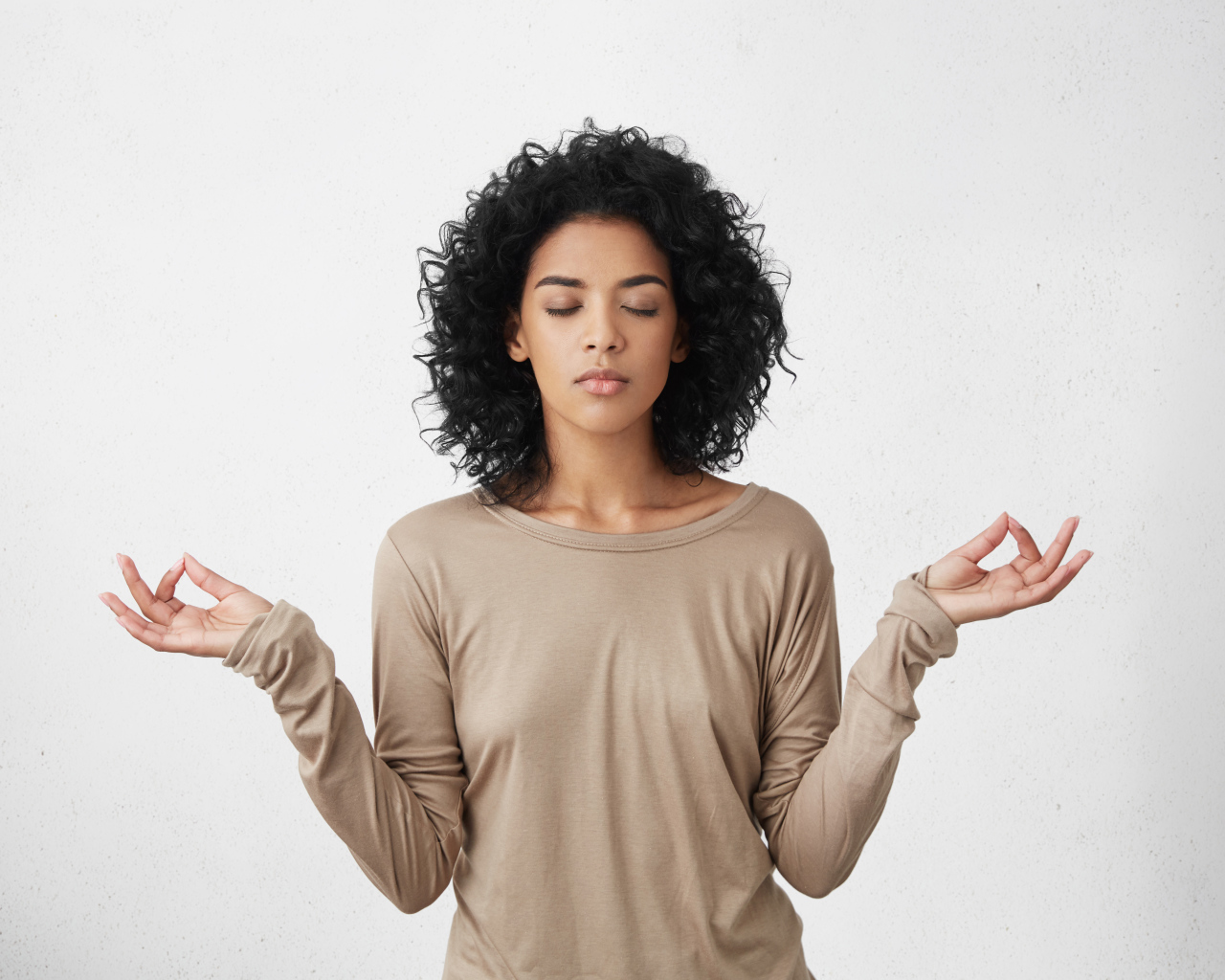 Девушка с закрытыми глазами медитирует 