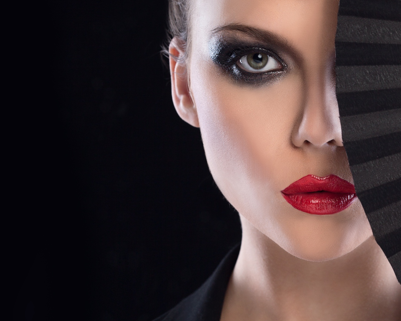 Девушка с макияжем закрывает лицо веером