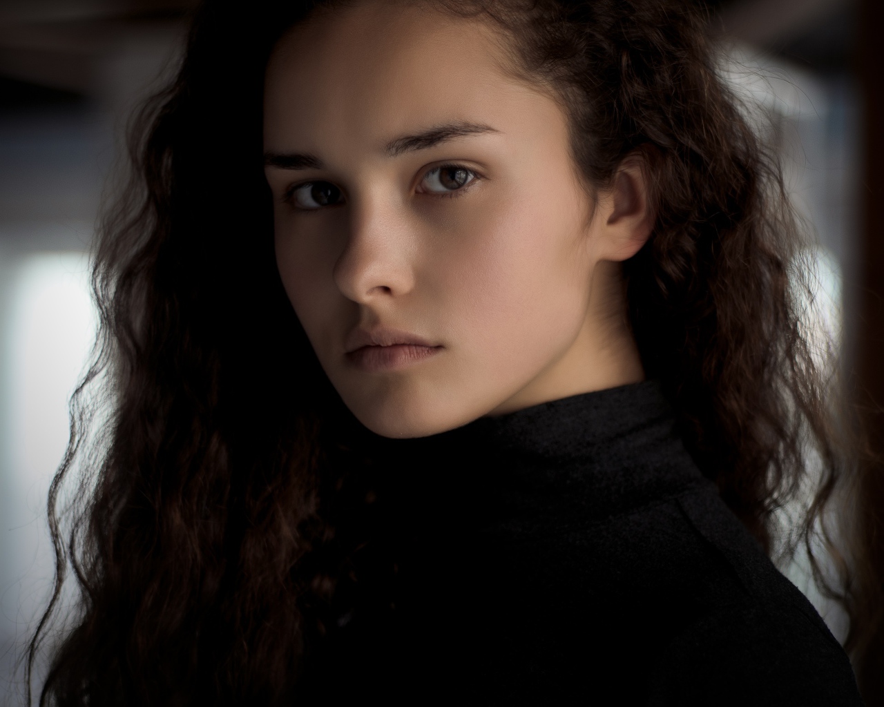 Грустная кареглазая девушка с длинными волосами