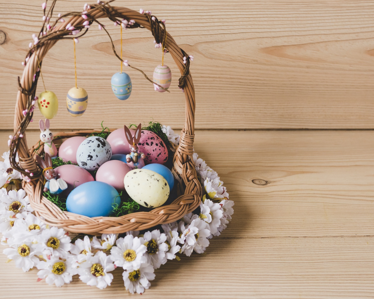 Корзинка с пасхальными яйцами украшена цветами