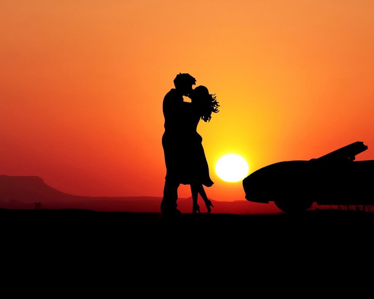 Kissing couple on sunset background with a car