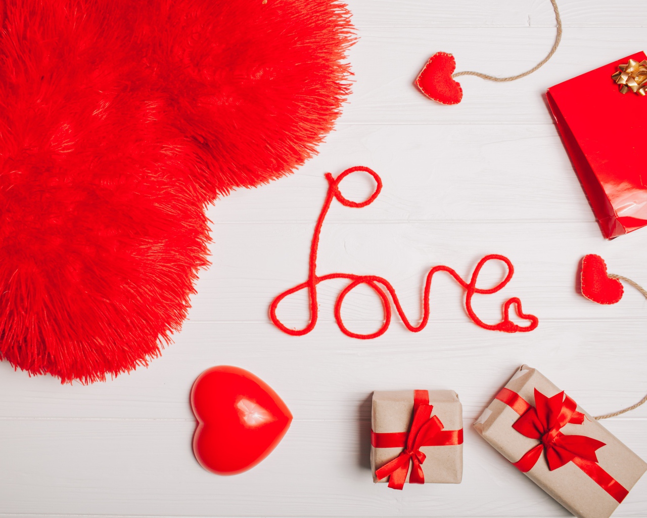 Большая подушка в форме сердца на столе с подарками 