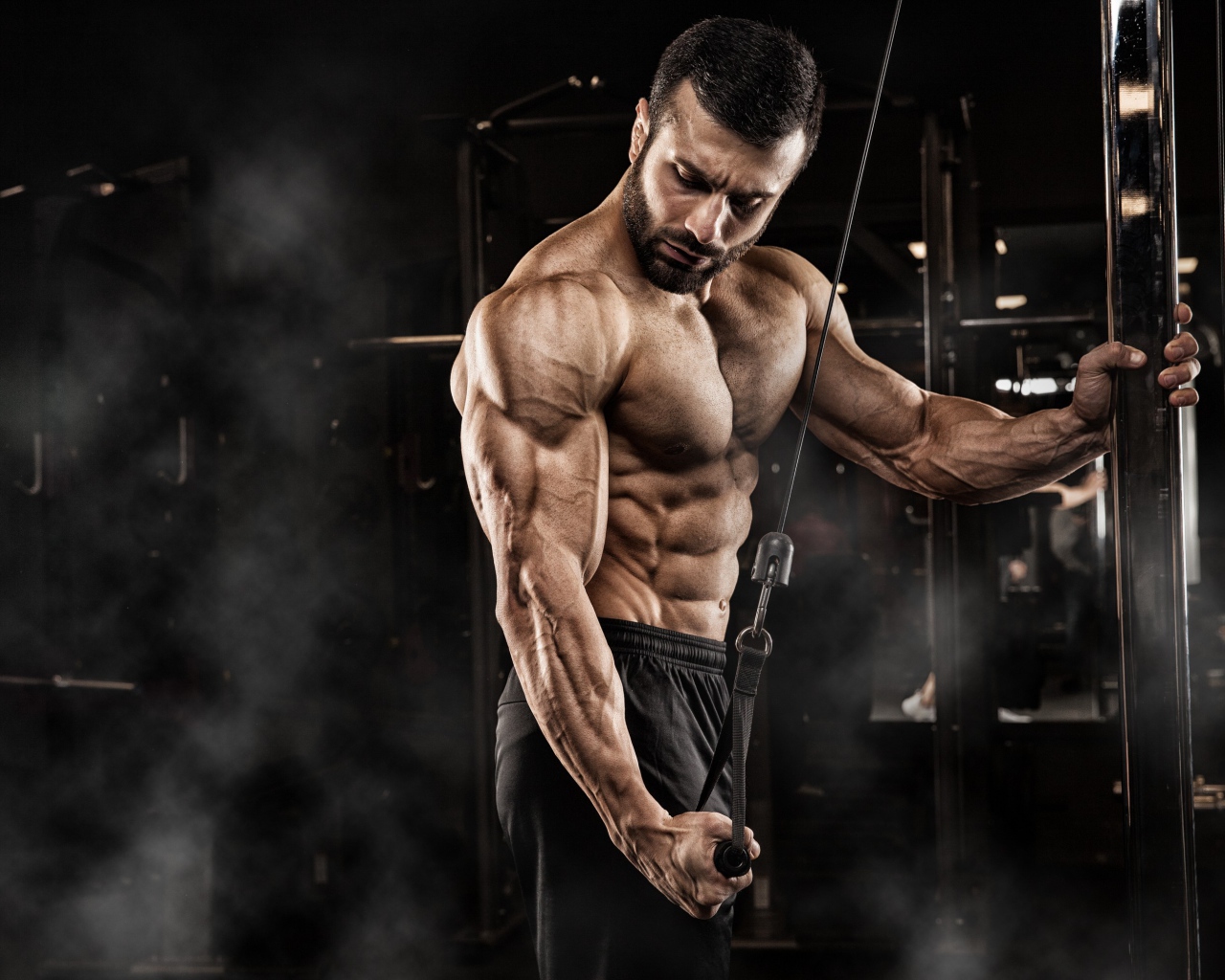 Сильный мужчина бодибилдер в спортзале