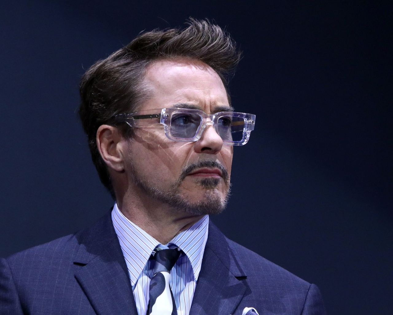 Актер Роберт Дауни-младший в костюме на синем фоне