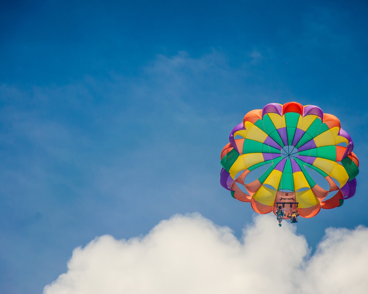 Parachute in the blue sky with white clouds