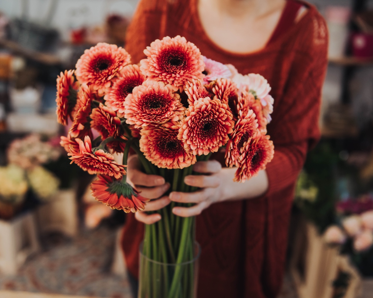 Красивый букет оранжевых гербер в руках у женщины 