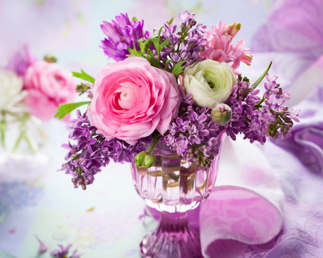 Beautiful buttercups and lilac flowers in a vase