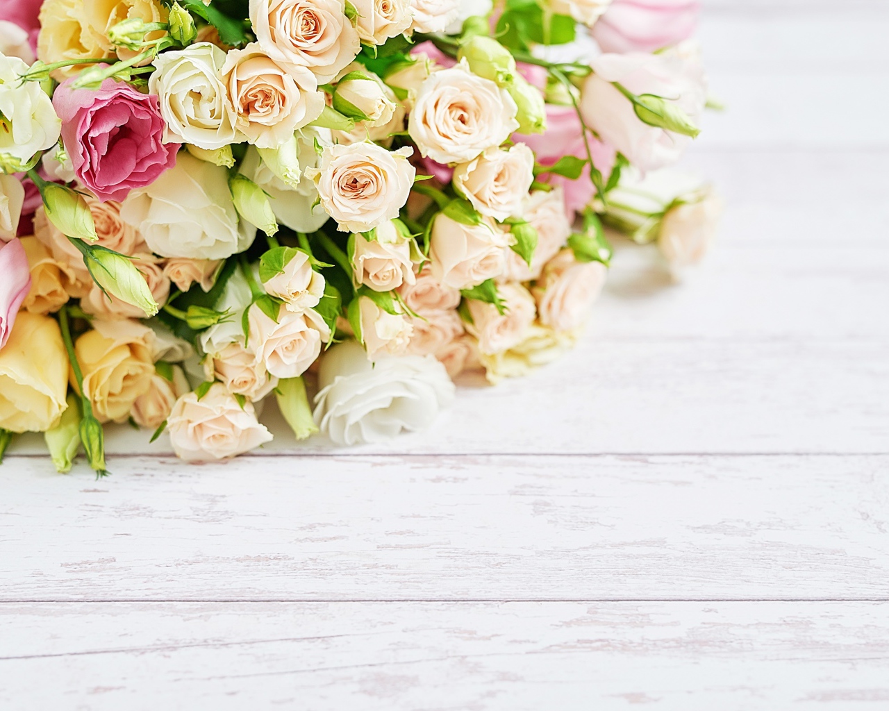 Красивый большой букет роз на белом столе