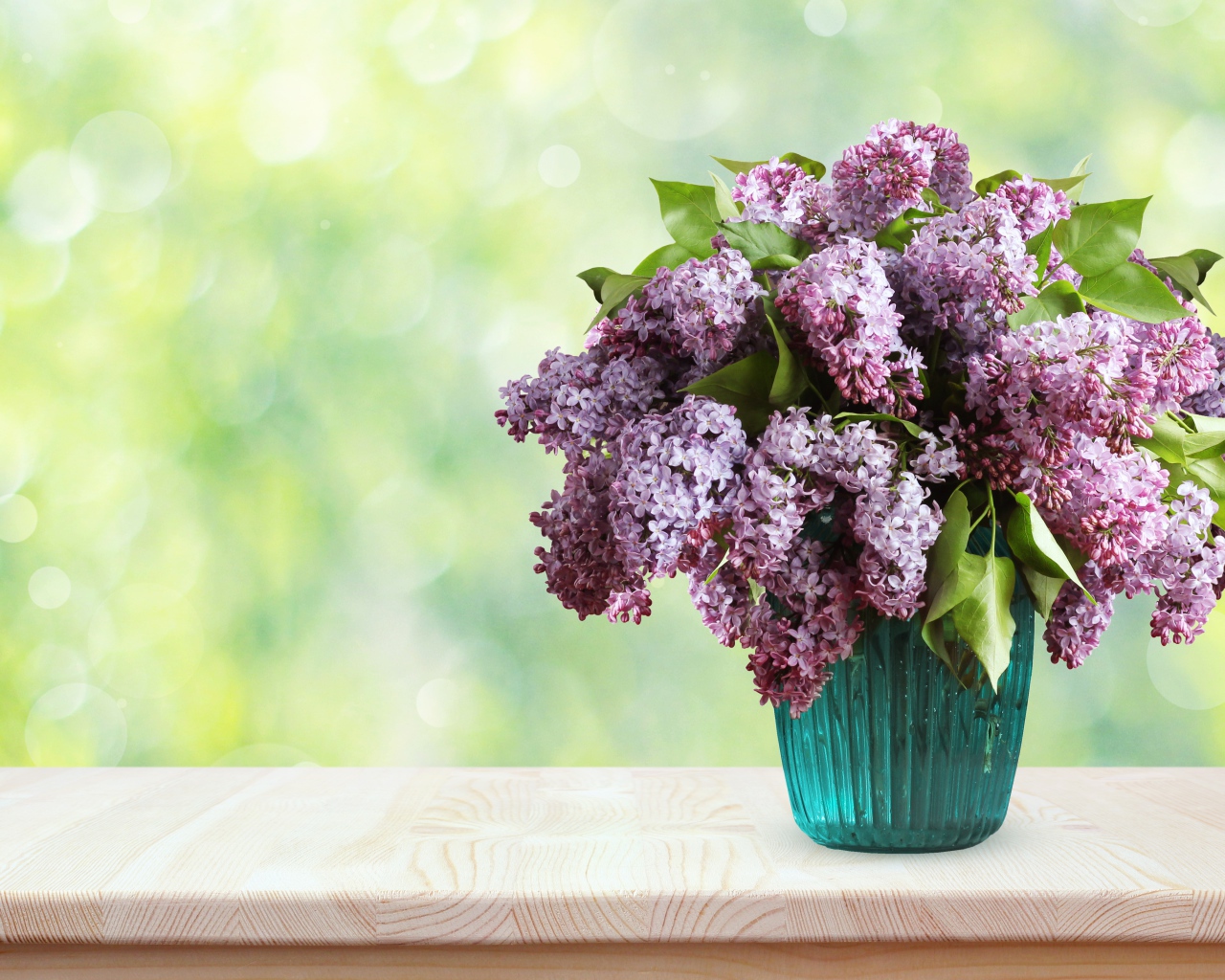 Букет ароматной сирени в вазе на столе