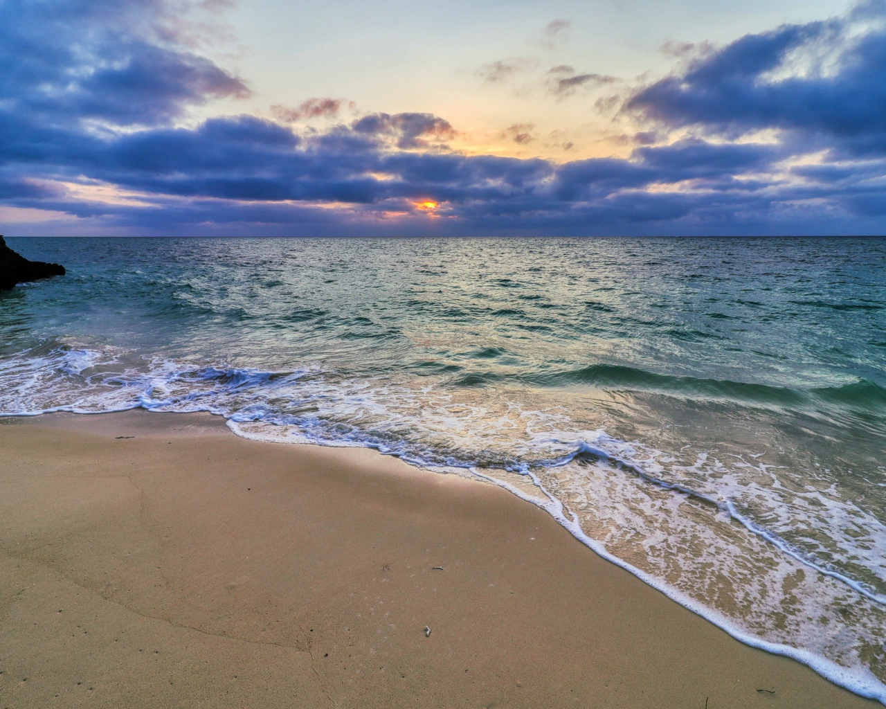 Голубая морская вода на песке на закате солнца