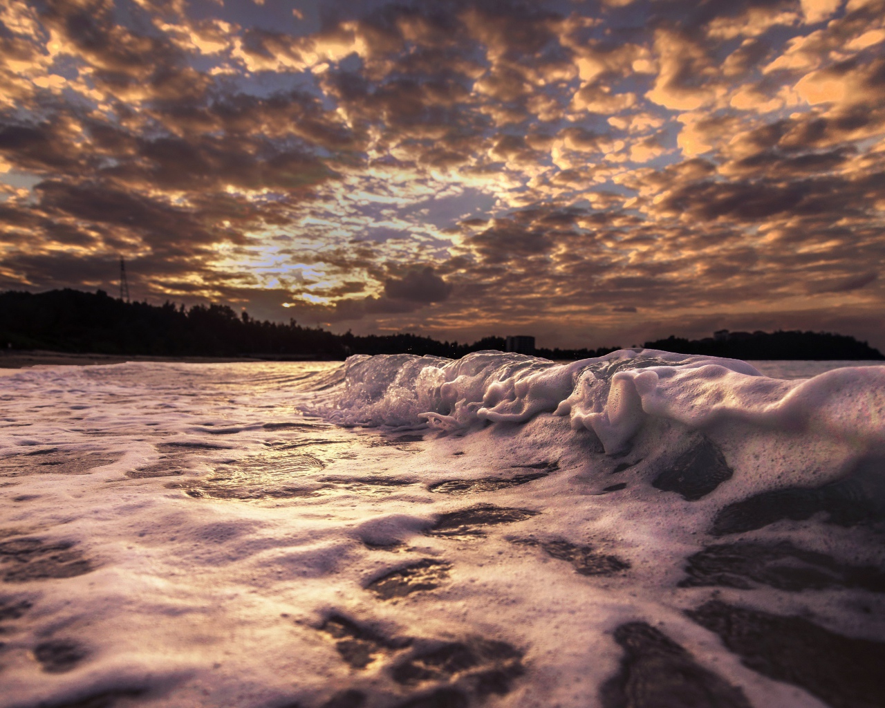 White waves in the sand at sunrise