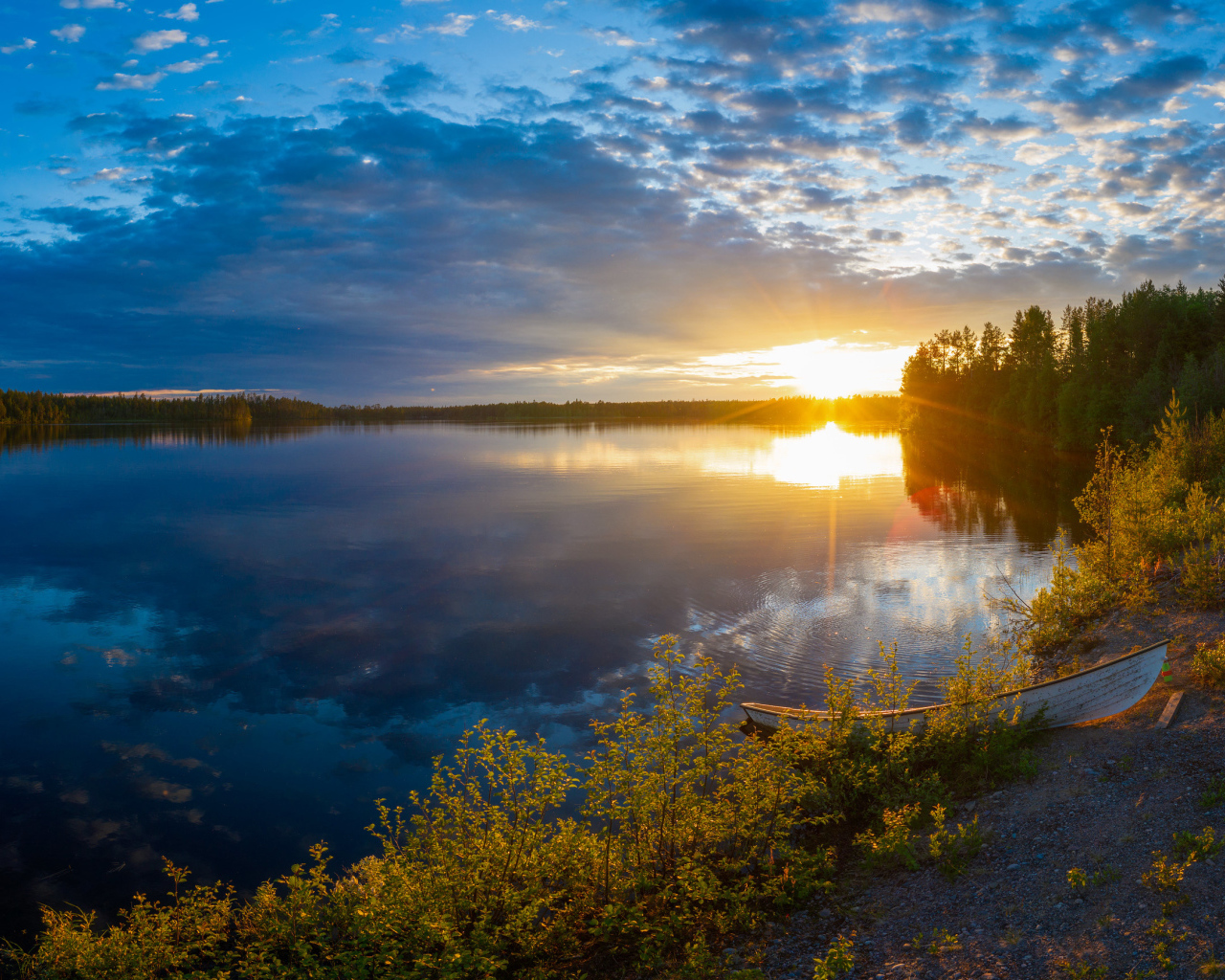 Закат солнца в небе над спокойным озером