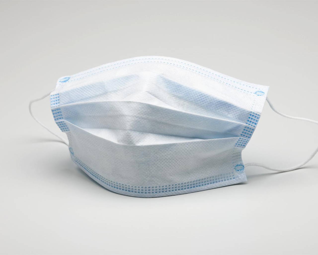 Медицинская маска защита от коронавирус covid-19 на сером фоне