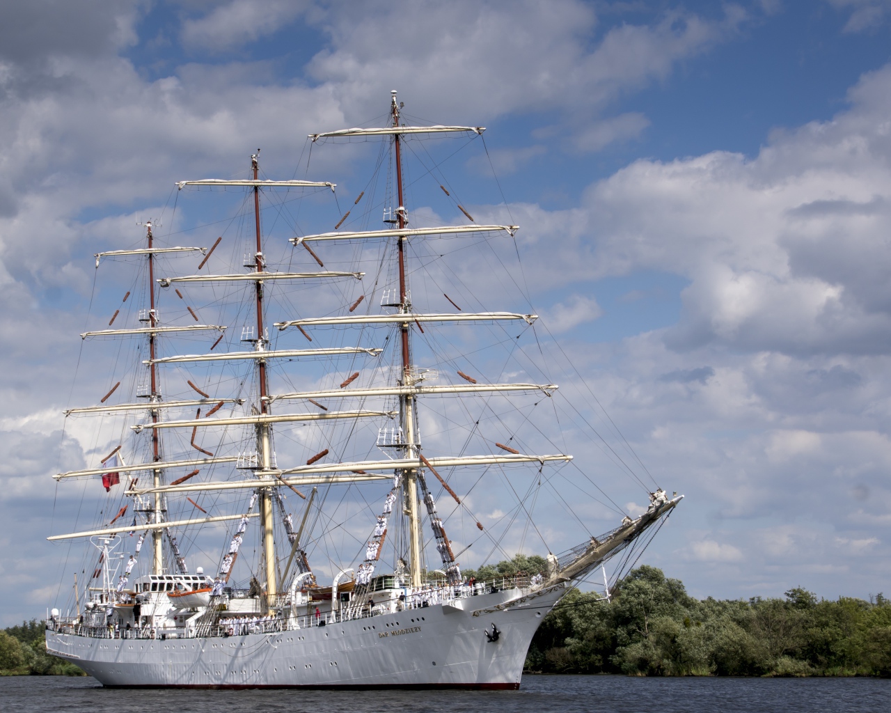 Large white ship with lowered sails