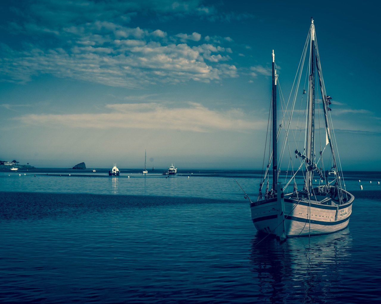 Sailing boat in the port at dusk