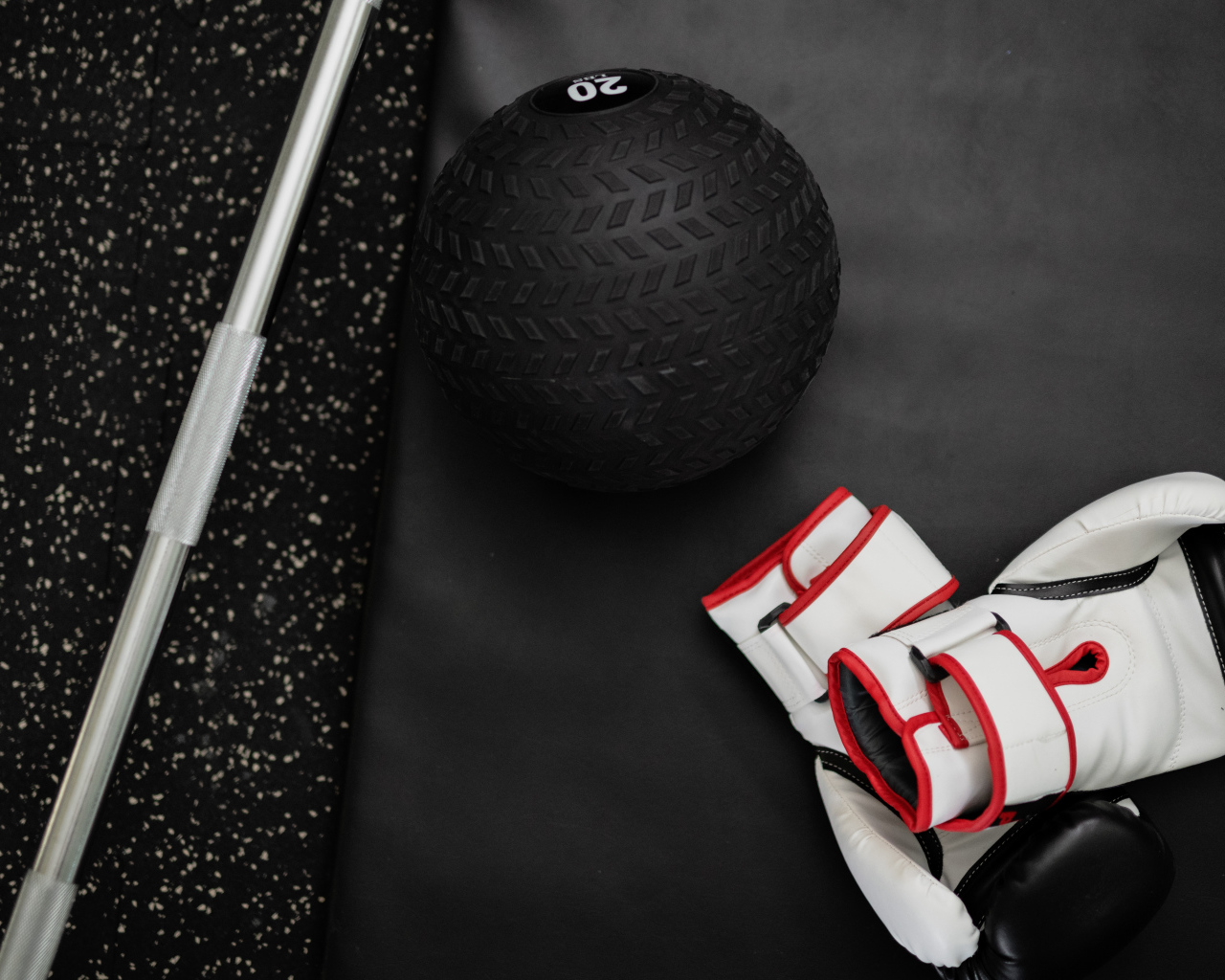 Gloves and a golf ball lie in the gym