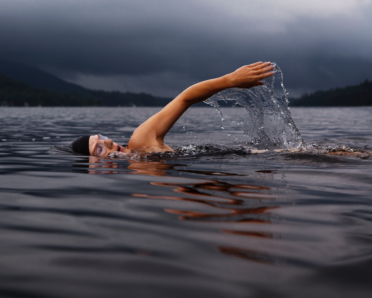 Male swimmer in the lake water