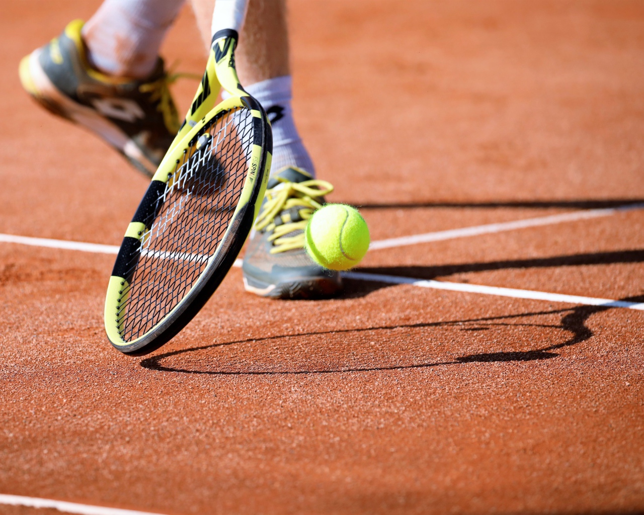 Мужчина играет на корте в теннис 