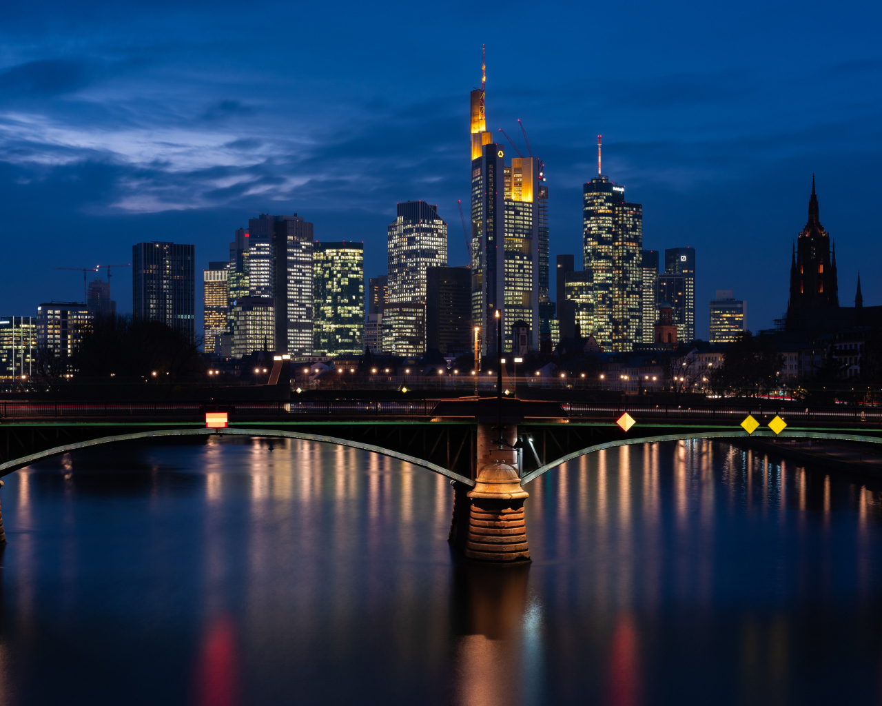 Небоскребы отражаются в воде ночью 