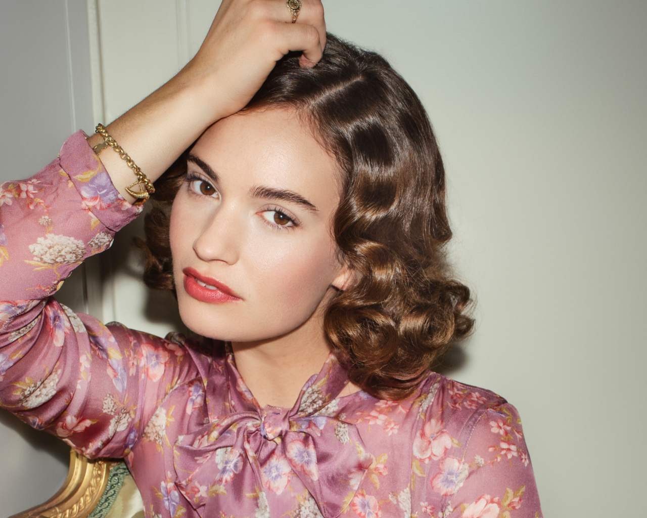 Актриса Лили Джеймс на сером фоне