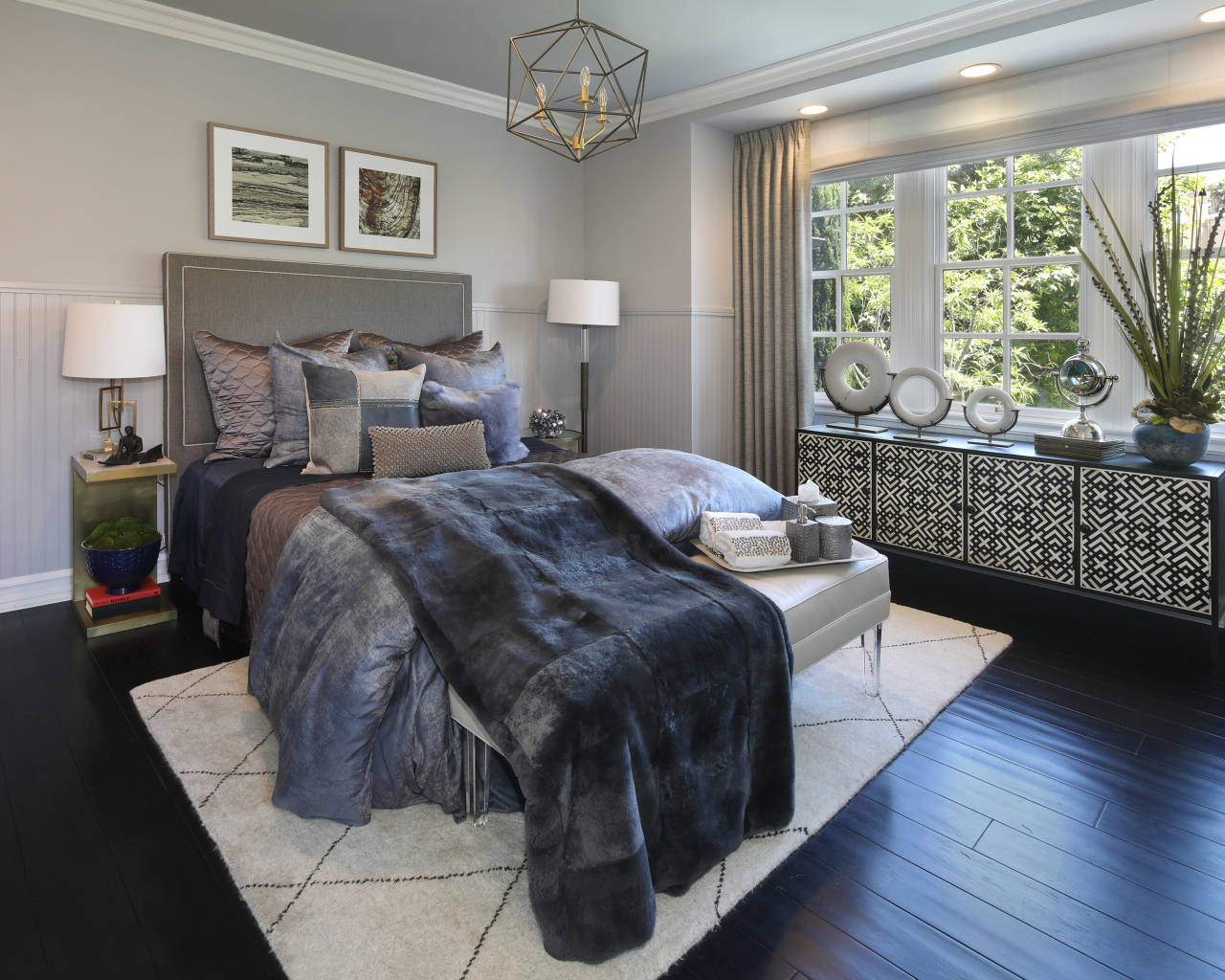 Large bed with soft gray bedspread in the bedroom