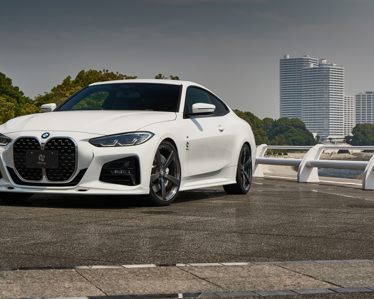Белый автомобиль BMW 4 Series Coupé M Sport Package 2021 года у города