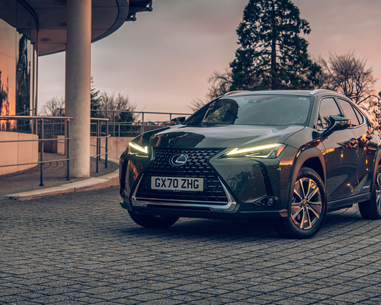 Автомобиль Lexus UX 300e 2021 года с включенными фарами