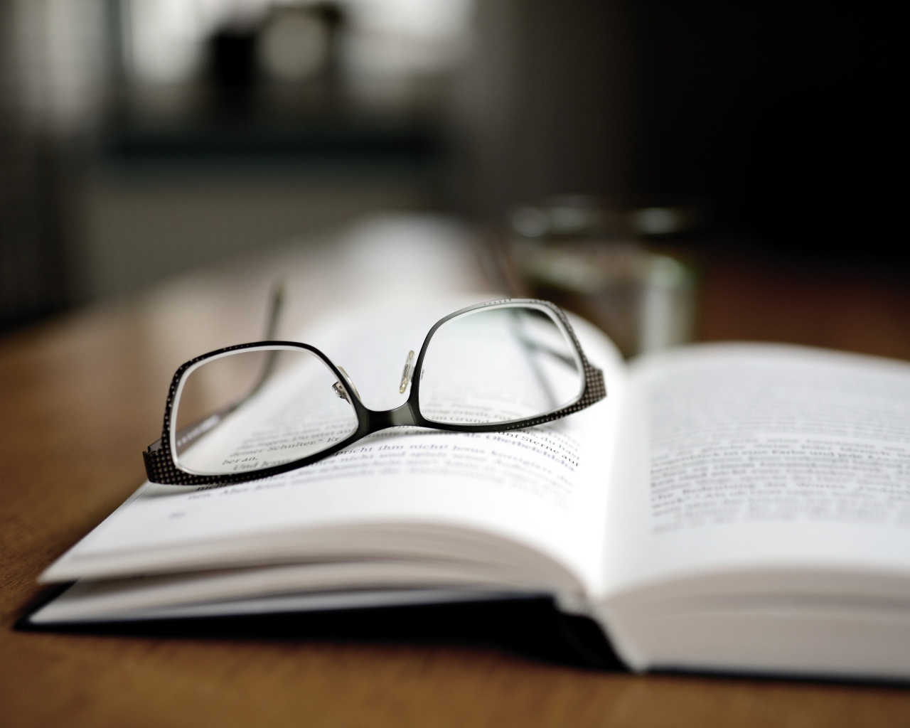 Black glasses lie on the book